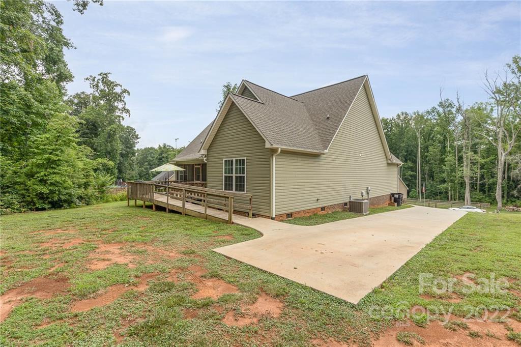 155 Rose Brier Lane. Salisbury, NC 28146 - Photo 28 of 32 a front view of house with yard and trees in the background