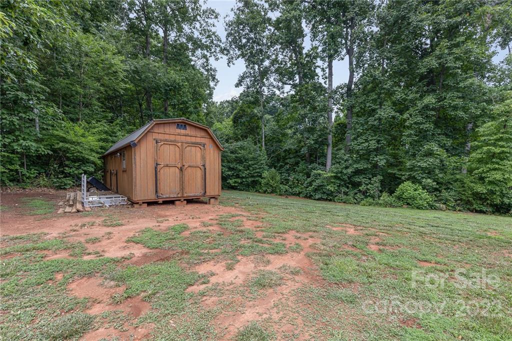 155 Rose Brier Lane. Salisbury, NC 28146 - Photo 32 of 32 a backyard of a house with a large tree and wooden fence