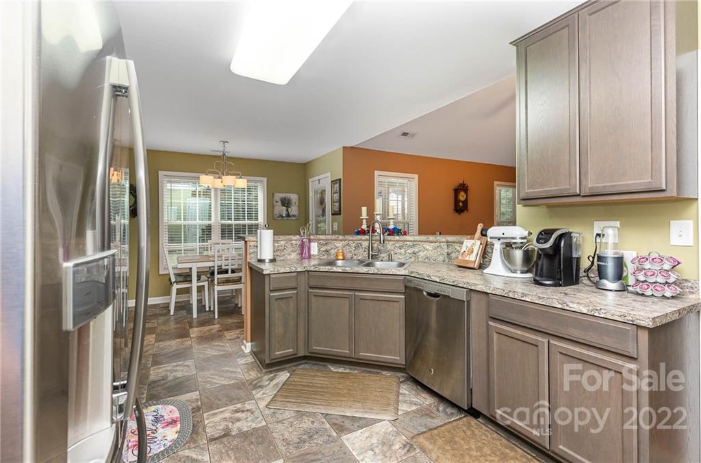 155 Rose Brier Lane. Salisbury, NC 28146 - Photo 8 of 32 a kitchen with granite countertop a sink stainless steel appliances and cabinets