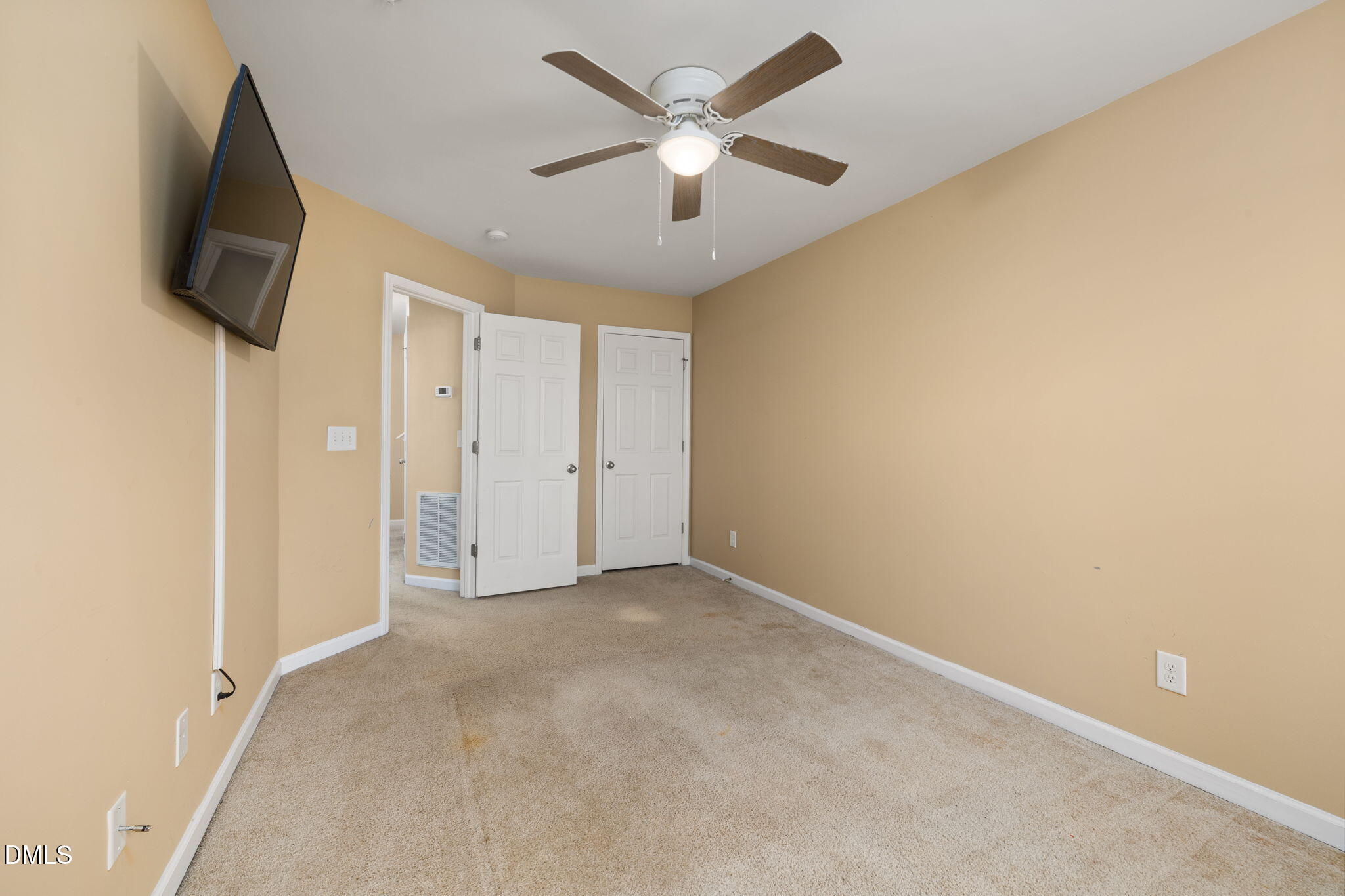 401 Coalinga Lane, Unit 108 Raleigh, NC 27610 - Photo 16 of 28 an empty room with windows and a ceiling fan