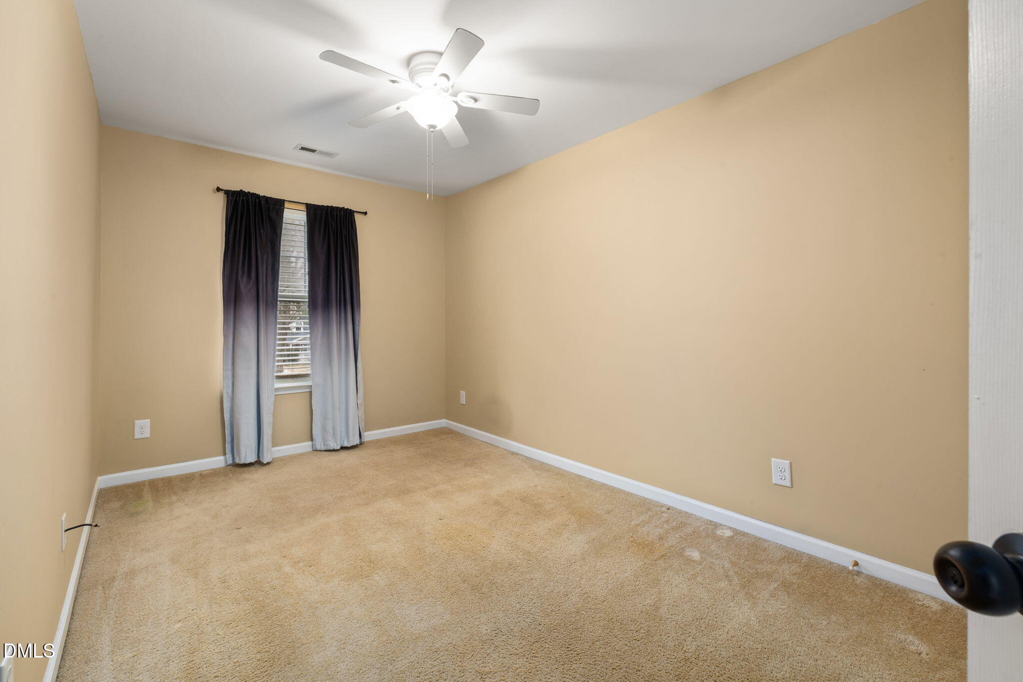 401 Coalinga Lane, Unit 108 Raleigh, NC 27610 - Photo 18 of 28 an empty room with a ceiling fan and a window