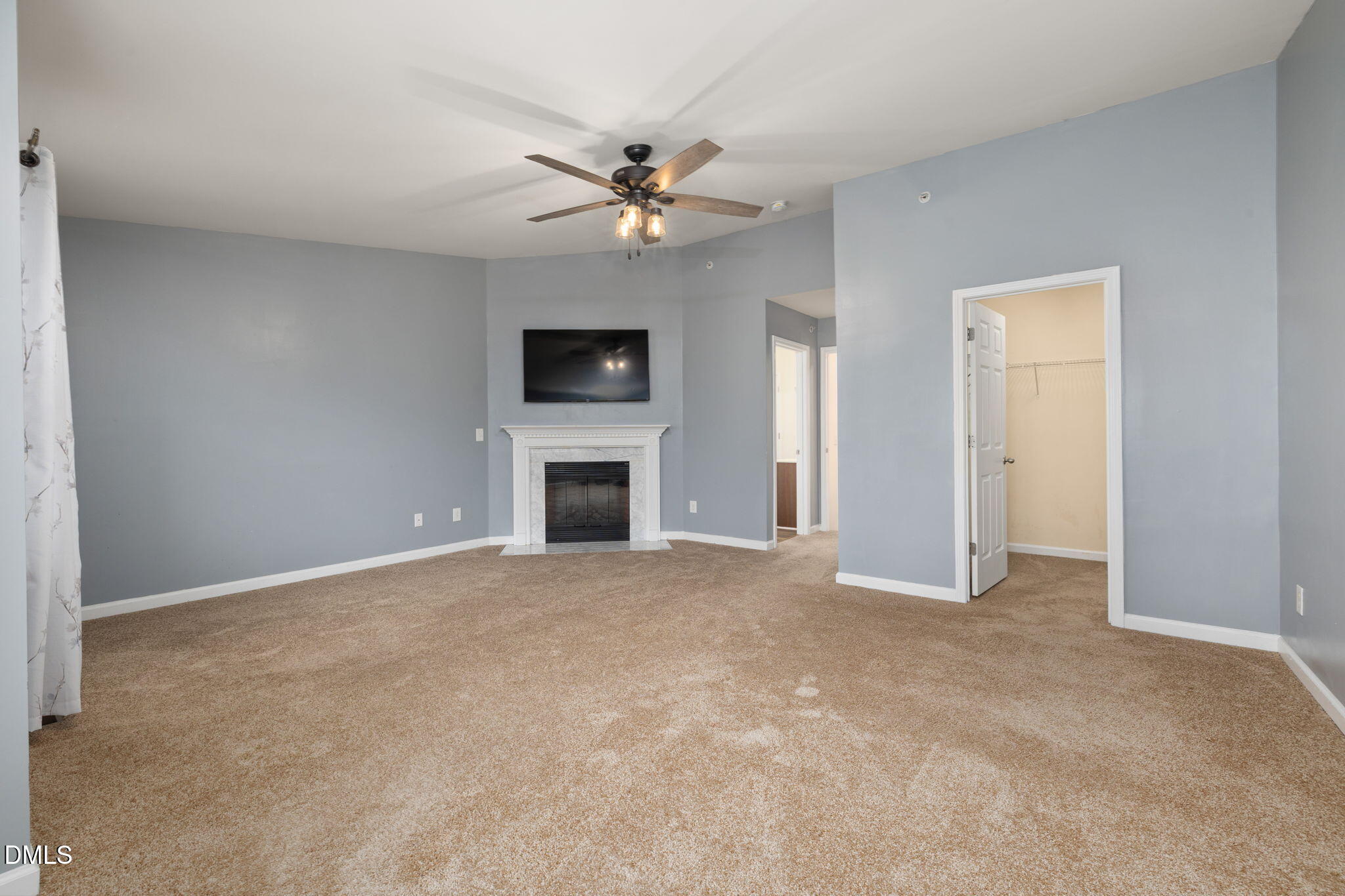 401 Coalinga Lane, Unit 108 Raleigh, NC 27610 - Photo 23 of 28 a view of empty room with fireplace and a ceiling fan