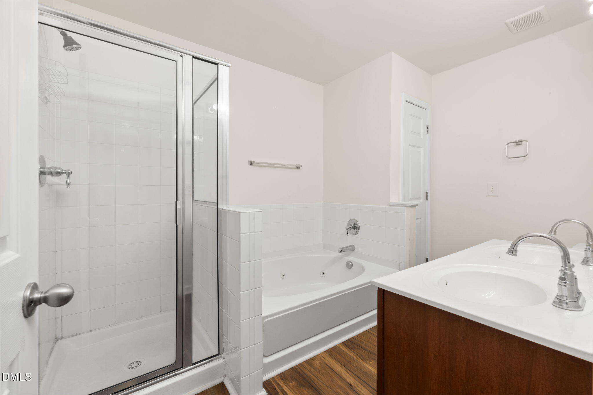401 Coalinga Lane, Unit 108 Raleigh, NC 27610 - Photo 26 of 28 a bathroom with a bathtub shower sink vanity and mirror