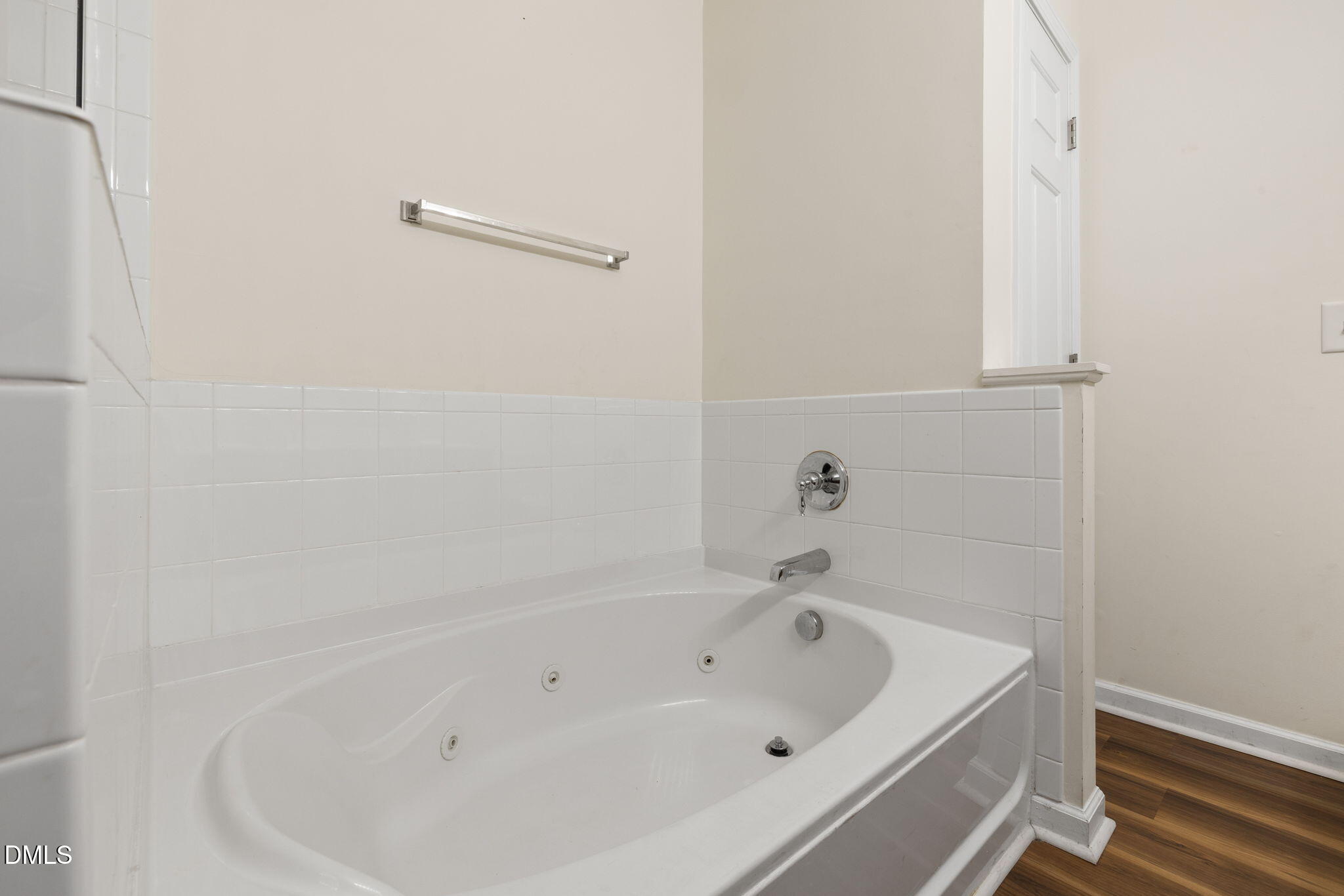 401 Coalinga Lane, Unit 108 Raleigh, NC 27610 - Photo 27 of 28 a white bath tub and shower in a bathroom