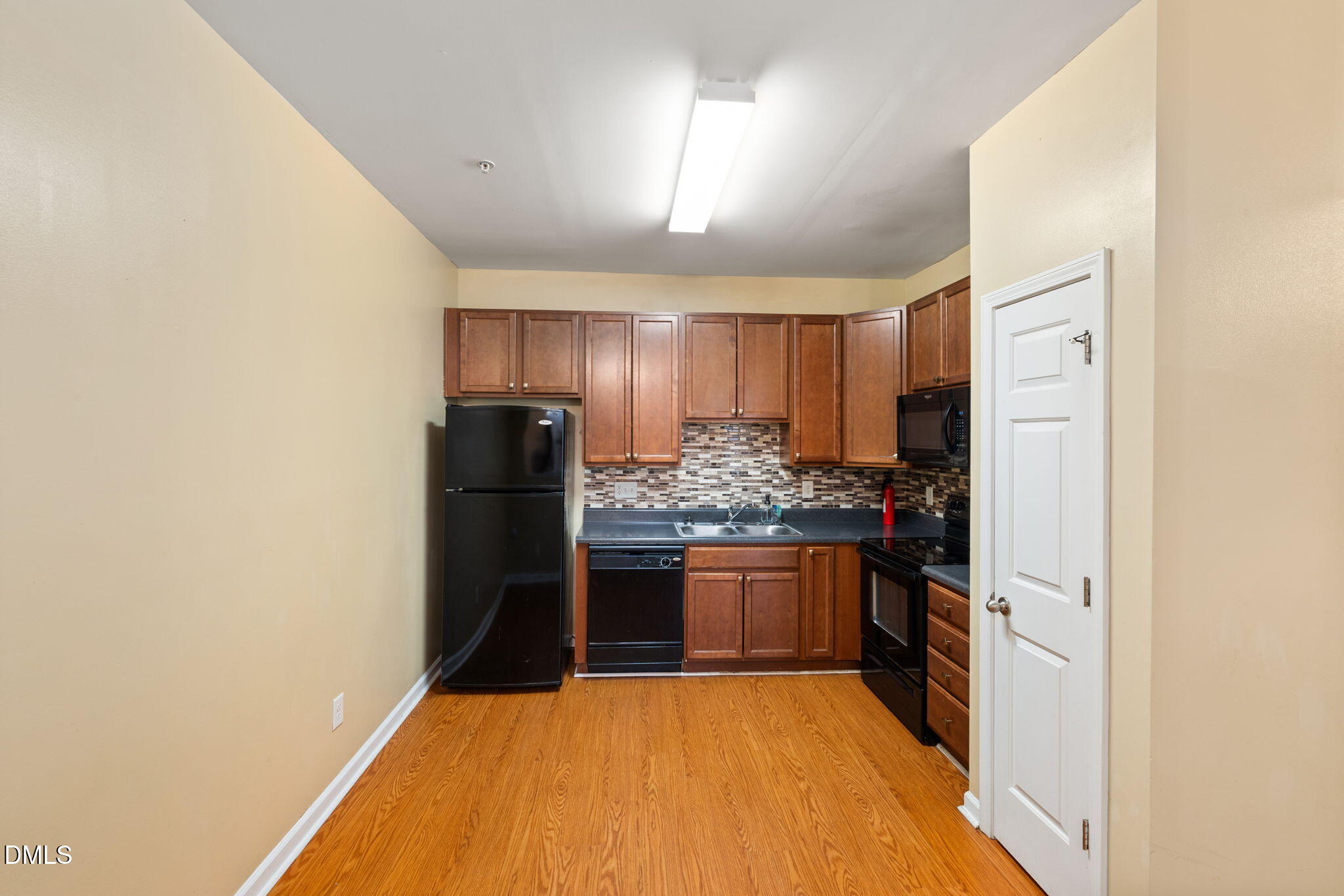 401 Coalinga Lane, Unit 108 Raleigh, NC 27610 - Photo 5 of 28 a kitchen with stainless steel appliances granite countertop a refrigerator and a stove