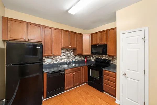 a kitchen with a refrigerator stove and microwave