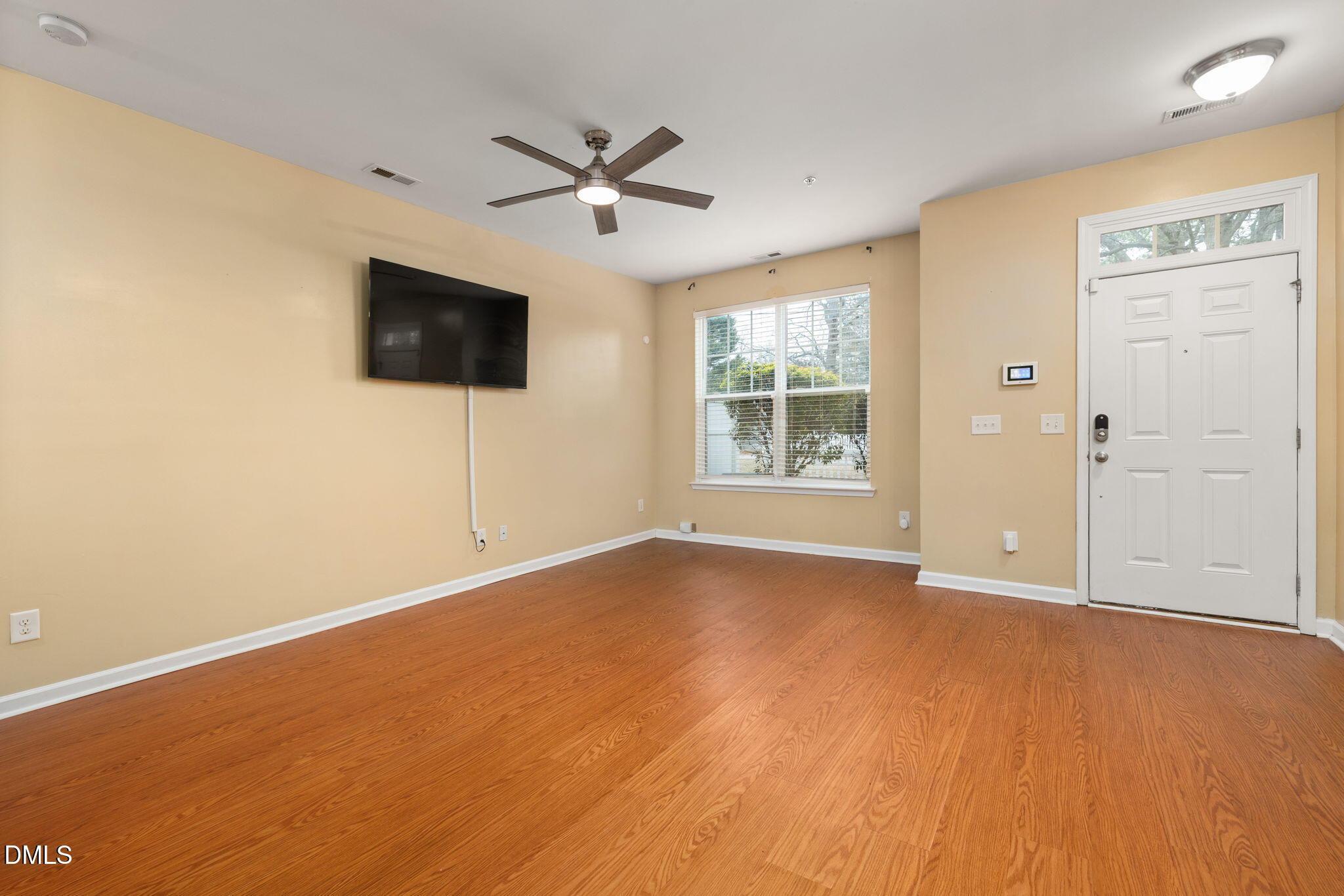 401 Coalinga Lane, Unit 108 Raleigh, NC 27610 - Photo 9 of 28 an empty room with windows and fireplace