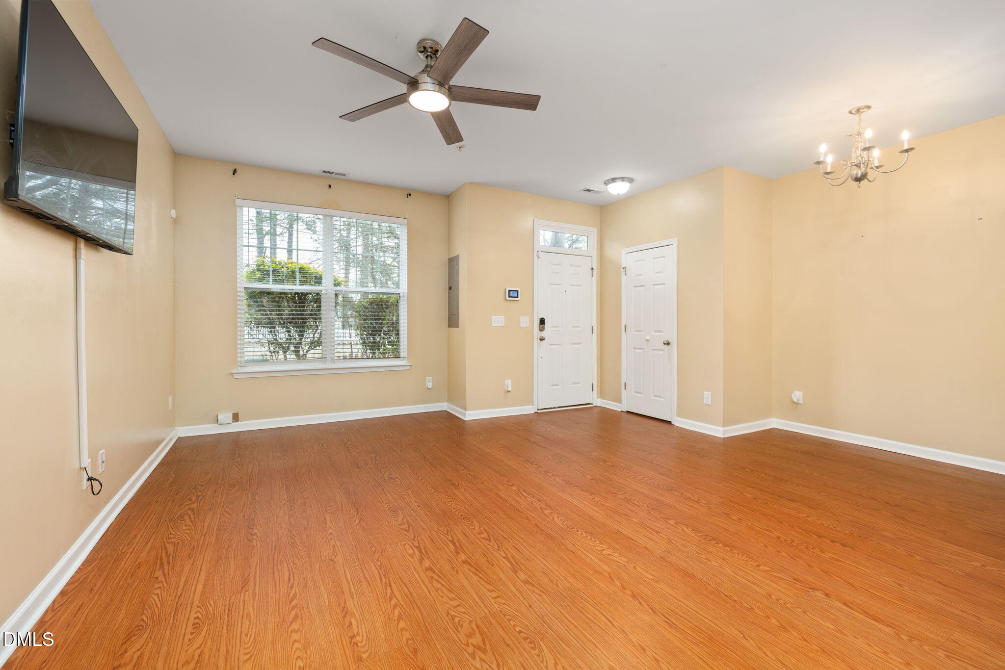 401 Coalinga Lane, Unit 108 Raleigh, NC 27610 - Photo 10 of 28 a view of an empty room with a window and a flat screen tv
