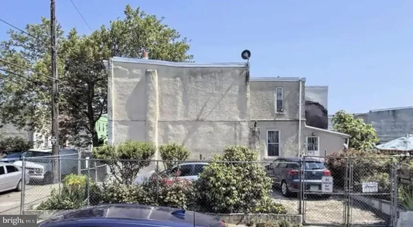 a front view of a house with plants