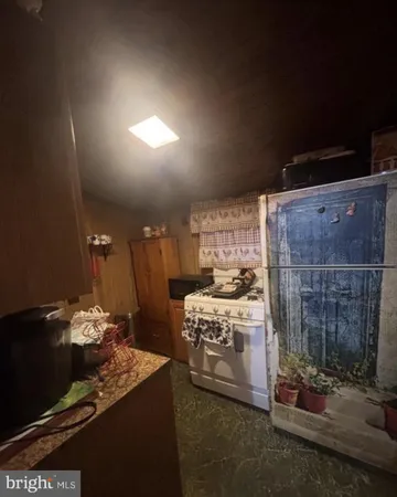 a kitchen with refrigerator and stove