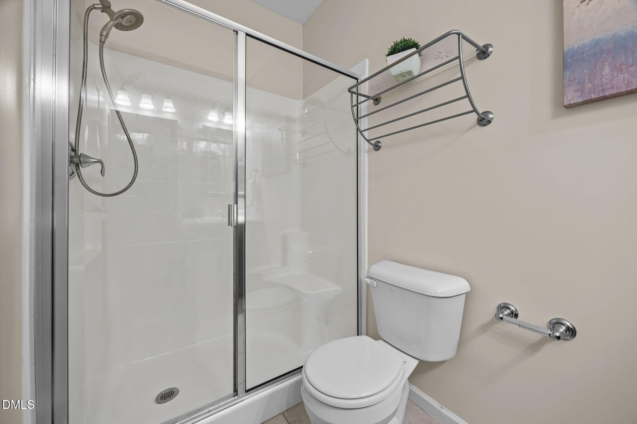 1430 Ardara Lane Raleigh, NC 27607 - Photo 12 of 25 a bathroom with a toilet and a glass shower door