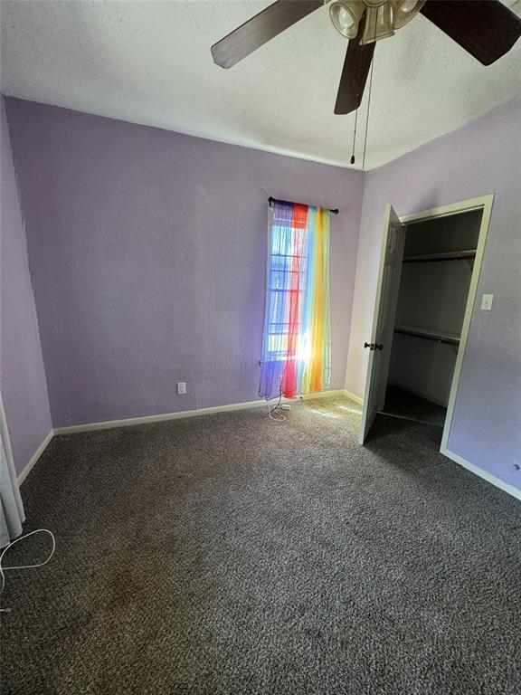 803 Ripley Avenue Ennis, TX 75119 - Photo 35 of 40 Carpeted room with a ceiling fan, closet access, and a window