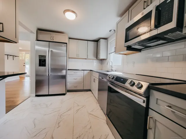a kitchen with a stove microwave and refrigerator