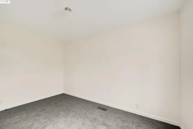 a view of an empty room with a fireplace