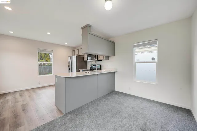 a kitchen with stainless steel appliances a refrigerator and a stove top oven