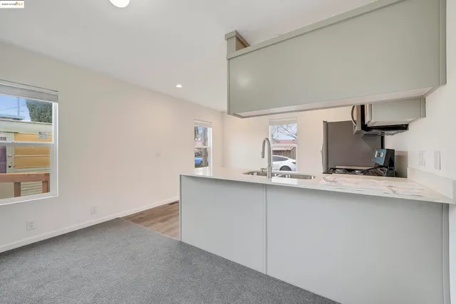 a kitchen with cabinets a sink and a wooden floor