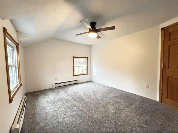 a view of a livingroom with a ceiling fan and window