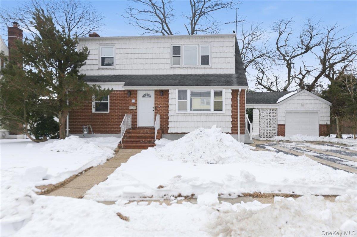 66 Elm Street Valley Stream, NY 11580 - Photo 1 of 23 a view of a house with snow on the road