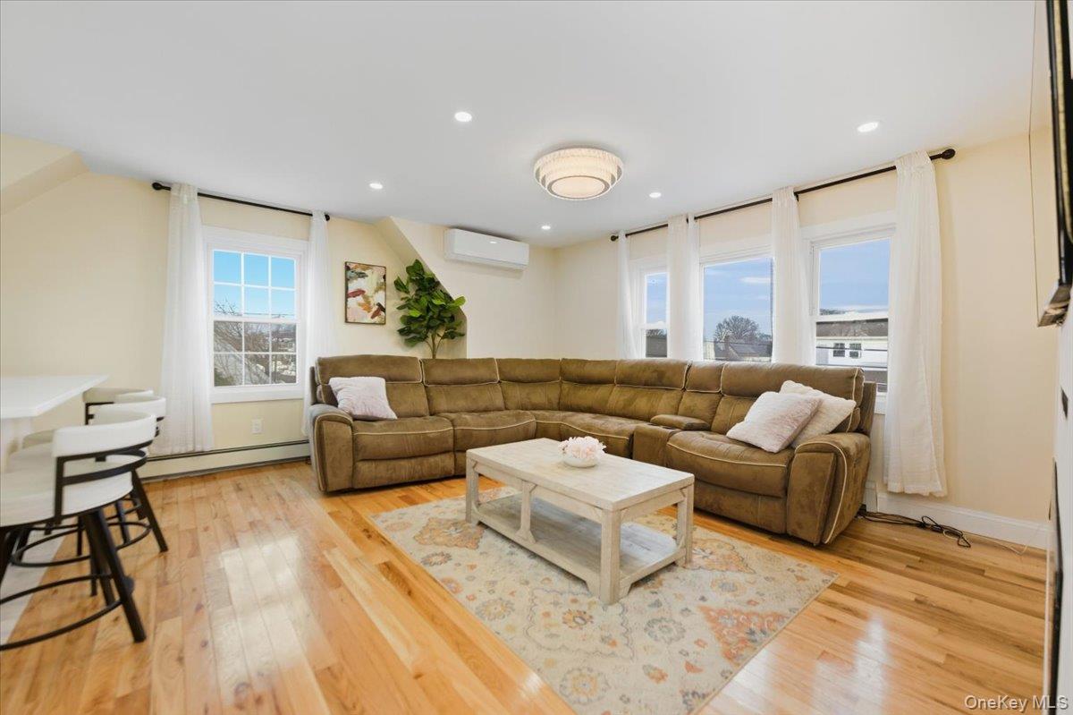 66 Elm Street Valley Stream, NY 11580 - Photo 11 of 23 a living room with furniture and wooden floor