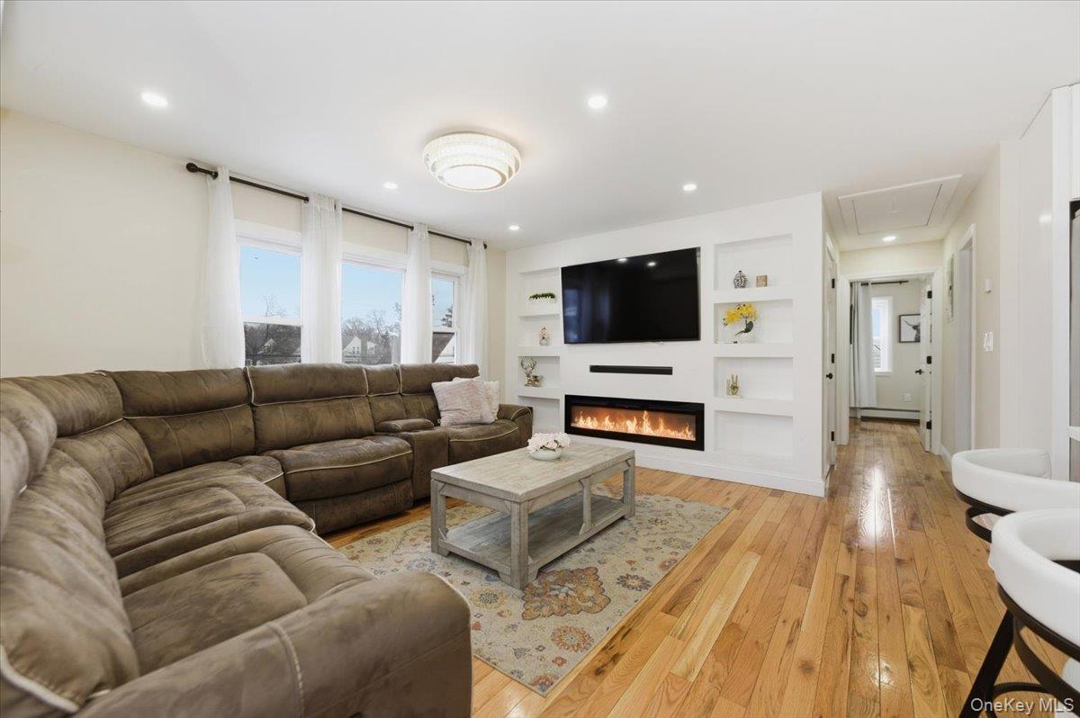 66 Elm Street Valley Stream, NY 11580 - Photo 12 of 23 a living room with furniture and a flat screen tv