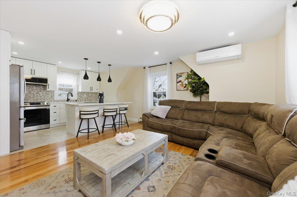 66 Elm Street Valley Stream, NY 11580 - Photo 13 of 23 a living room with furniture and a kitchen