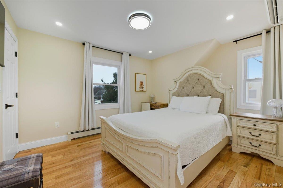 66 Elm Street Valley Stream, NY 11580 - Photo 17 of 23 a large bed sitting in a bedroom next to a window