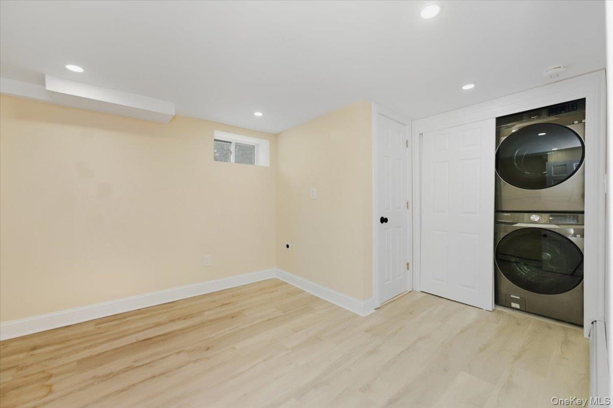 66 Elm Street Valley Stream, NY 11580 - Photo 19 of 23 a view of an empty room with wooden floor and a window