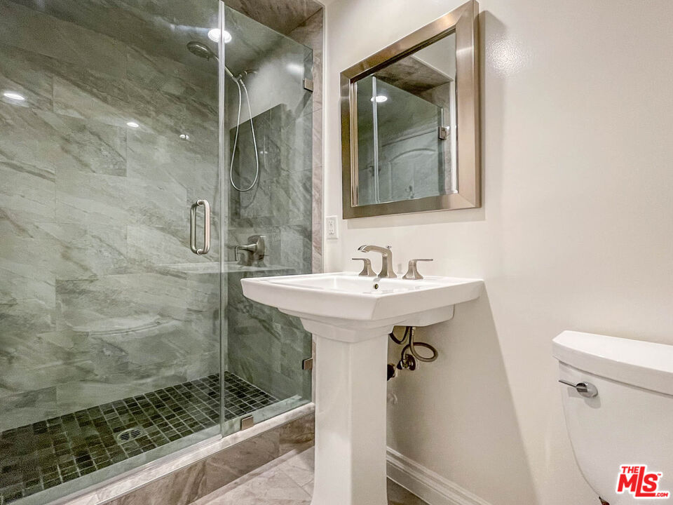 3824 Surfwood Road Malibu, CA 90265 - Photo 11 of 36 a bathroom with a sink and mirror