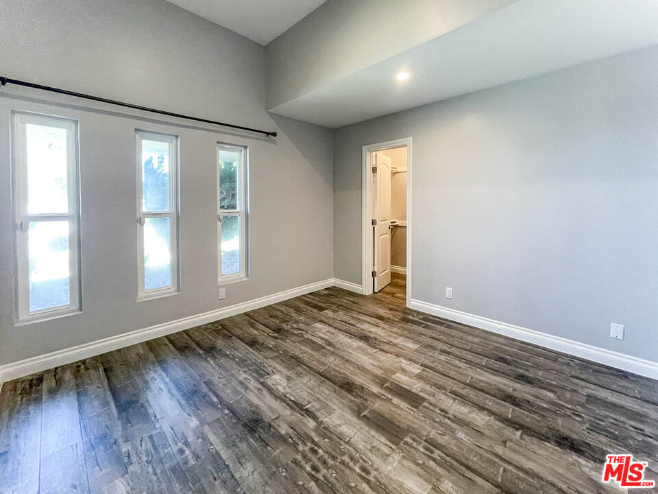 3824 Surfwood Road Malibu, CA 90265 - Photo 19 of 36 a view of an empty room with wooden floor and a window