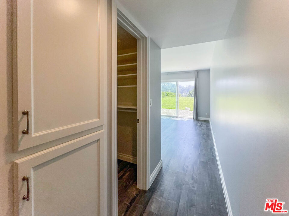 3824 Surfwood Road Malibu, CA 90265 - Photo 25 of 36 a view of a hallway with wooden floor
