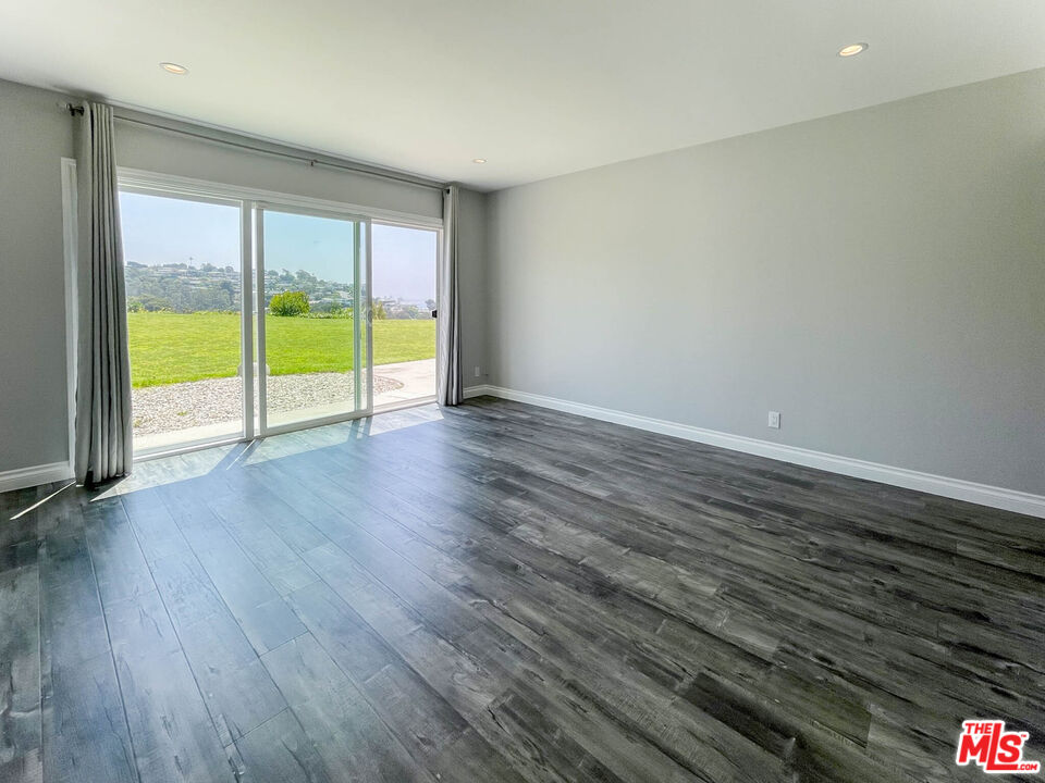 3824 Surfwood Road Malibu, CA 90265 - Photo 27 of 36 a view of an empty room with wooden floor