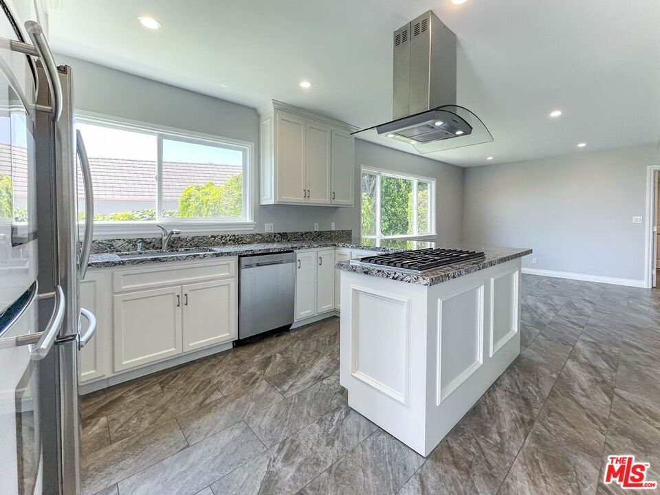 3824 Surfwood Road Malibu, CA 90265 - Photo 8 of 36 a kitchen with stainless steel appliances granite countertop a stove a sink and a microwave