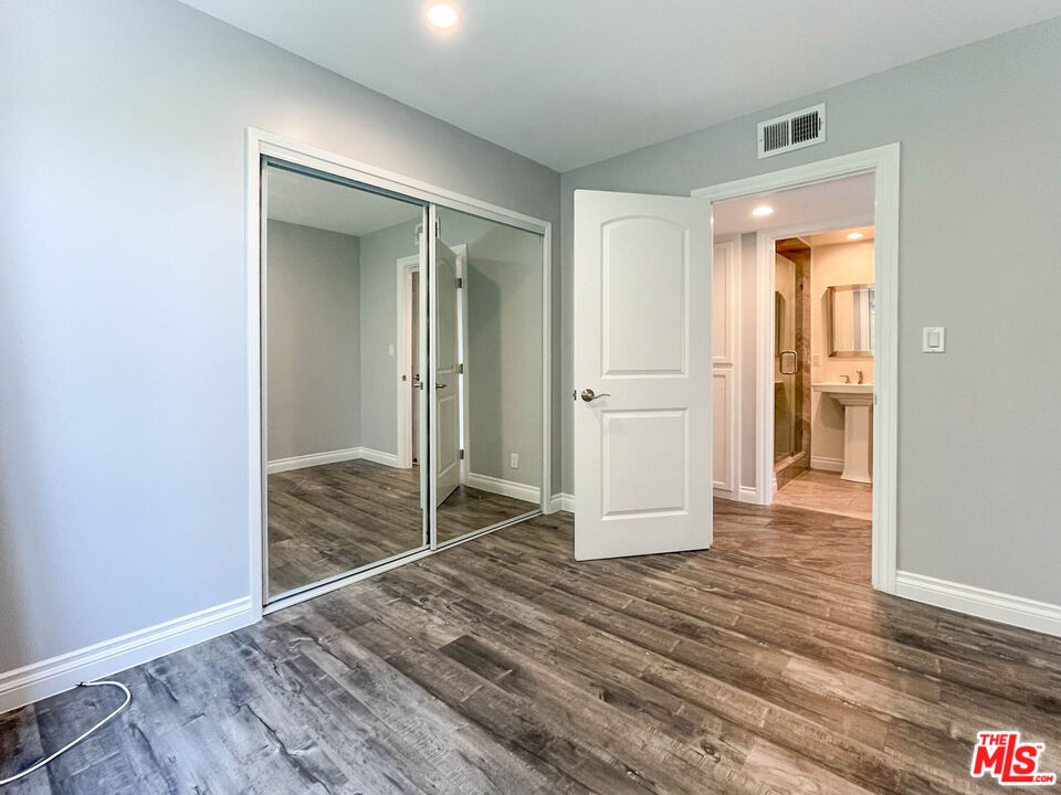3824 Surfwood Road Malibu, CA 90265 - Photo 9 of 36 a view of a hallway with wooden floor and closet