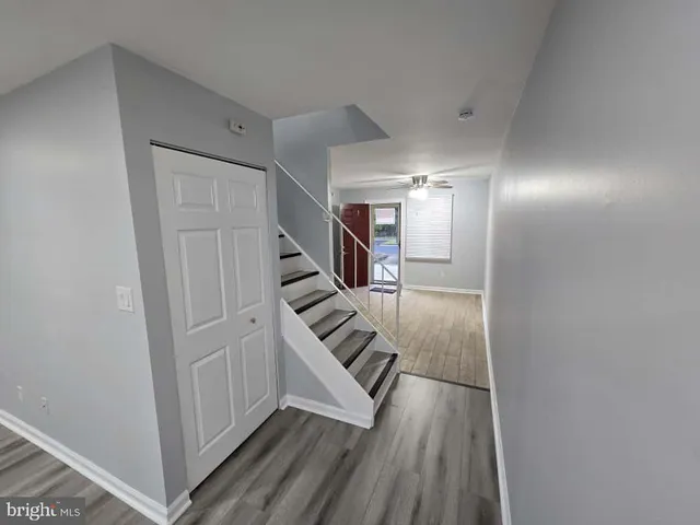 a view of an entryway with wooden floor