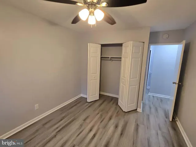 wooden floor in an empty room with a mirror