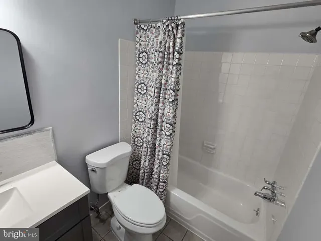 a white toilet sitting next to a bath tub