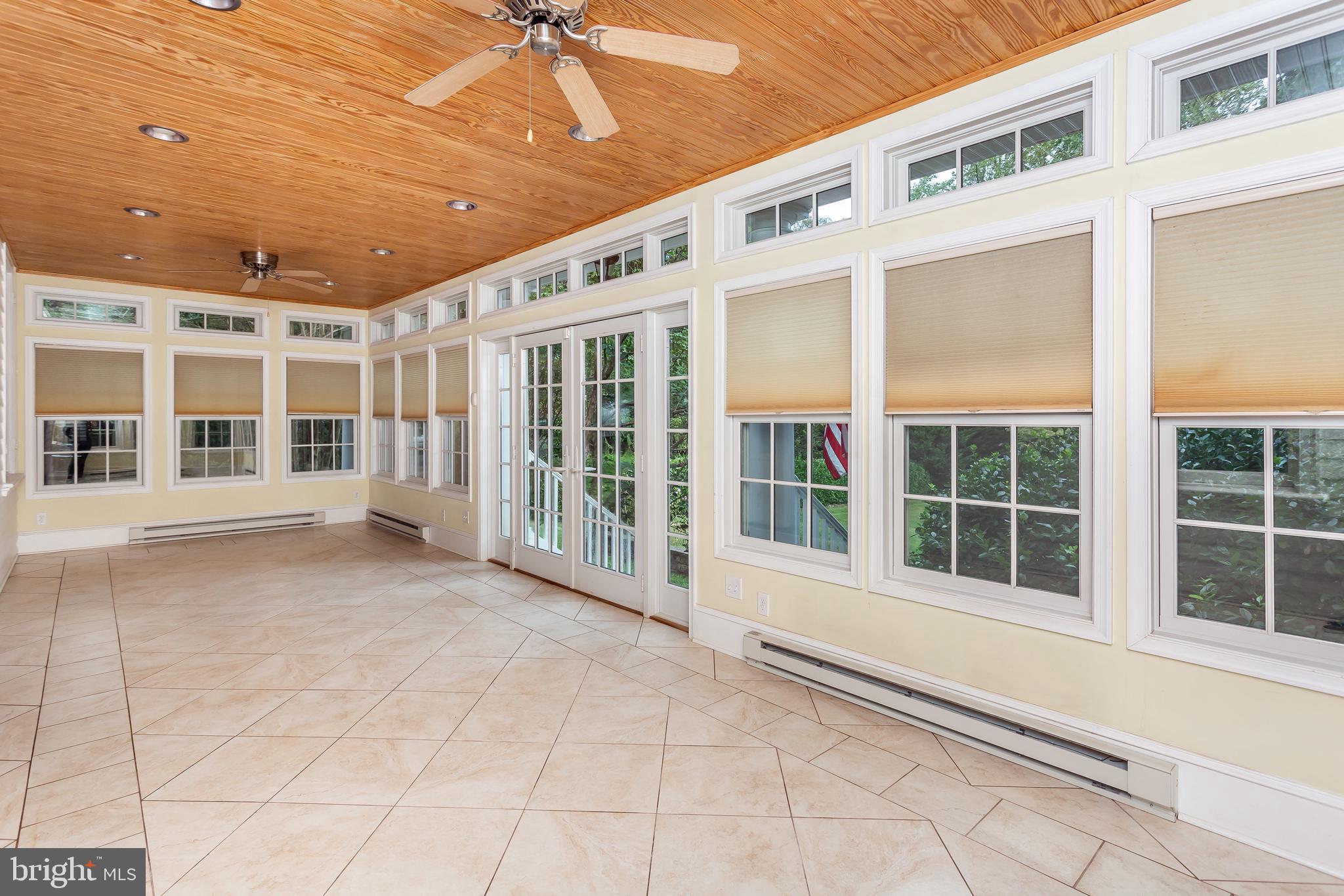 509 Woodlawn Road Baltimore, MD 21210 - Photo 44 of 76 Enclosed Sunroom Looking out onto the Lawn