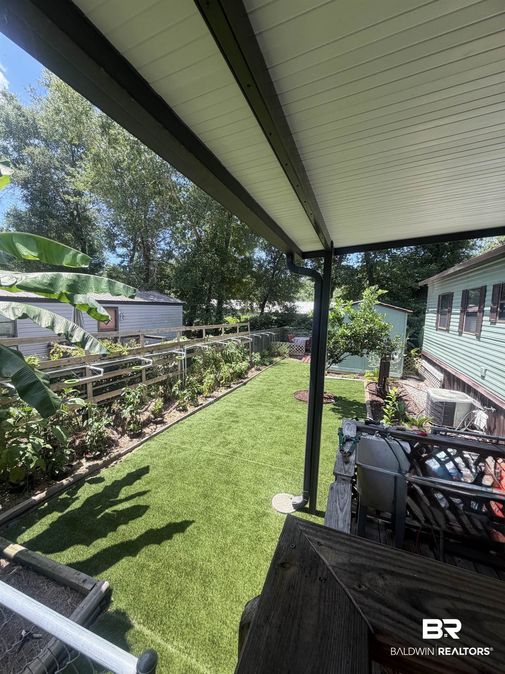1620 Del Rey Drive Lillian, AL 36549 - Photo 6 of 45 Covered patio with white paneling and dark support beams