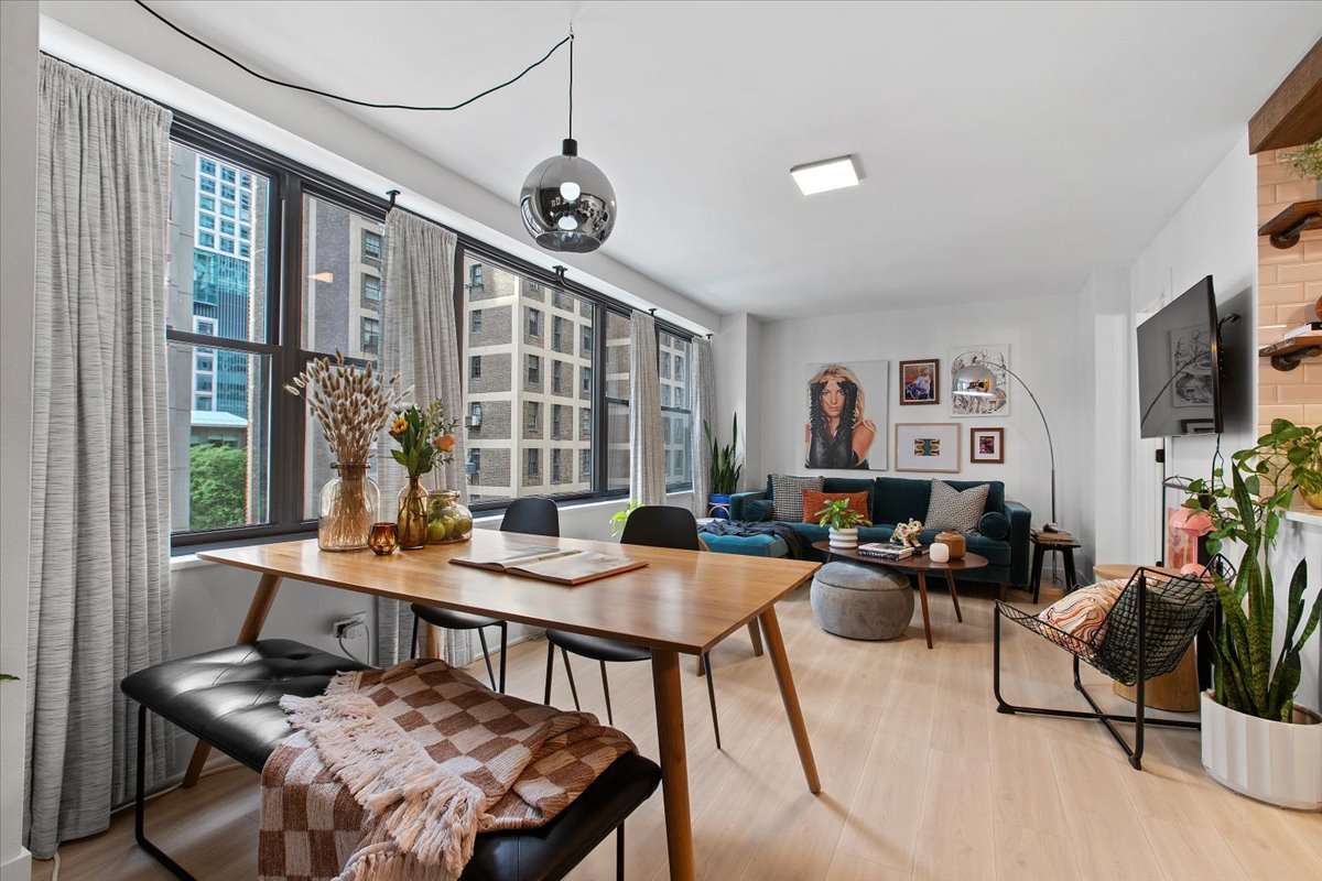 850 North Dewitt Place, Unit 7F Chicago, IL 60611 - Photo 5 of 13 a view of a livingroom and dining room with furniture window and wooden floor