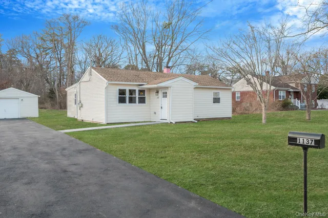 a front view of house with yard and green space
