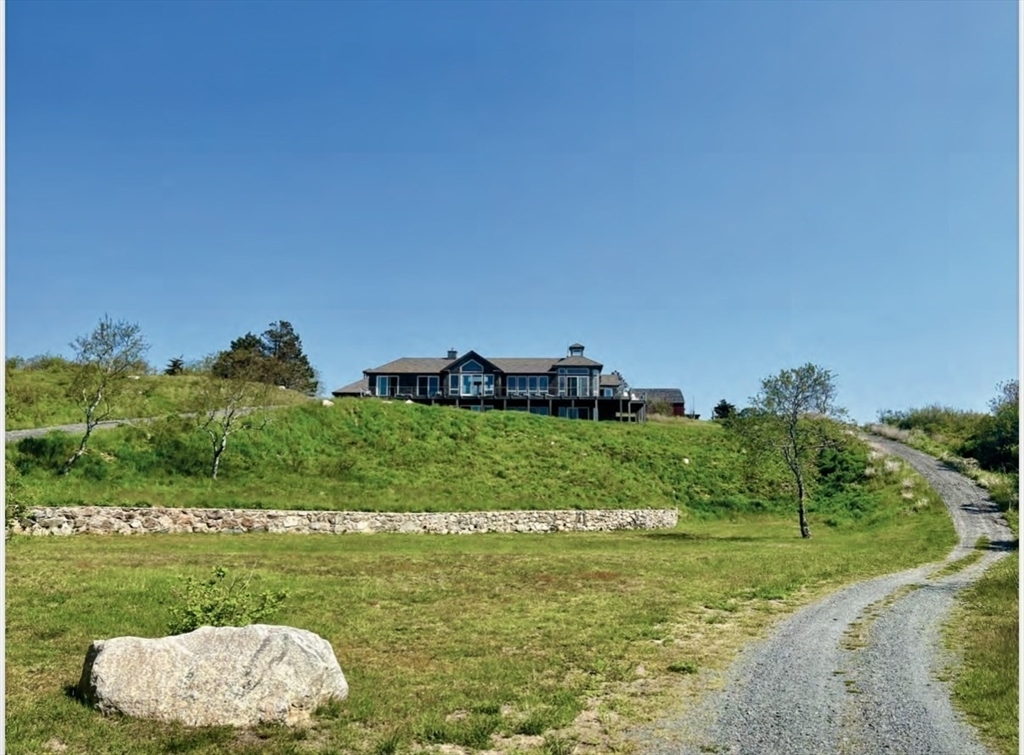 0 West End Road Cuttyhunk, MA 02713 - Photo 2 of 21 a view of a back yard of the house and green space
