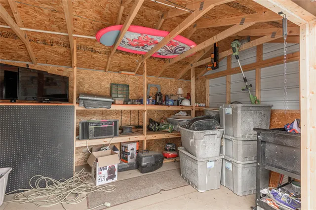 a view of a green field with wooden fence