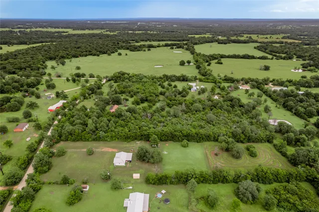 an aerial view of a houses with a yard