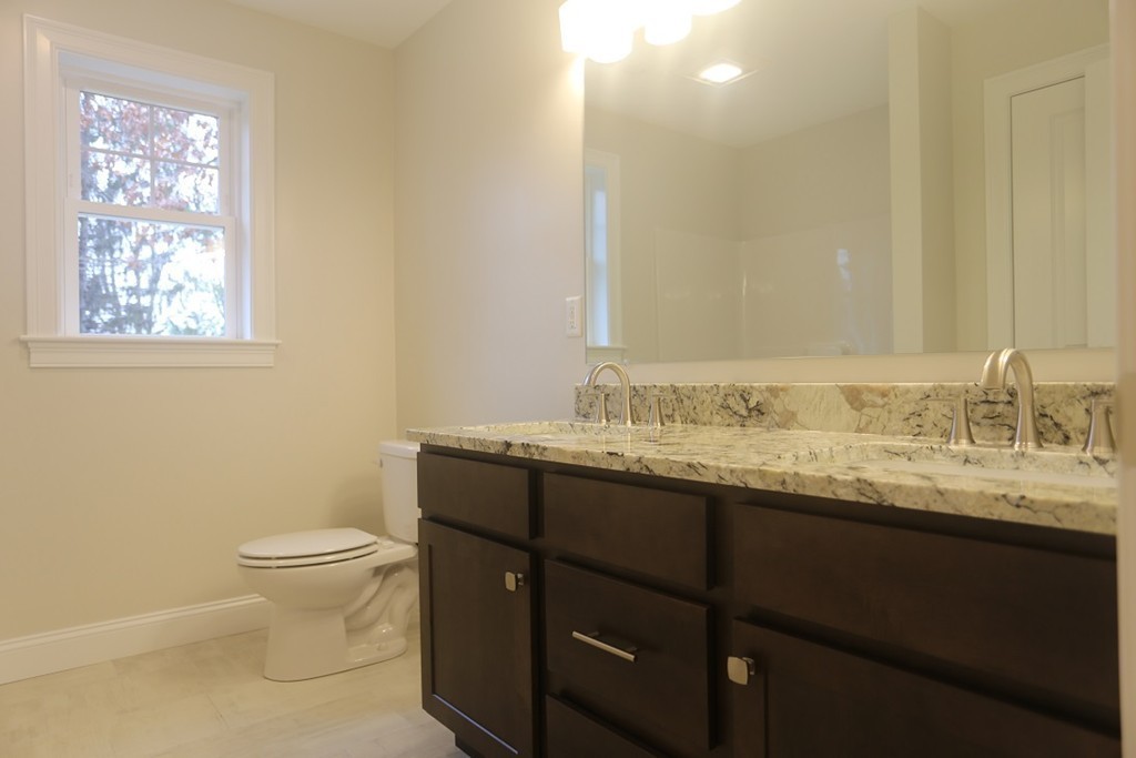 Lot 6 Littleton Road Ayer, MA 01432 - Photo 7 of 11 a bathroom with a granite countertop sink a toilet and a mirror