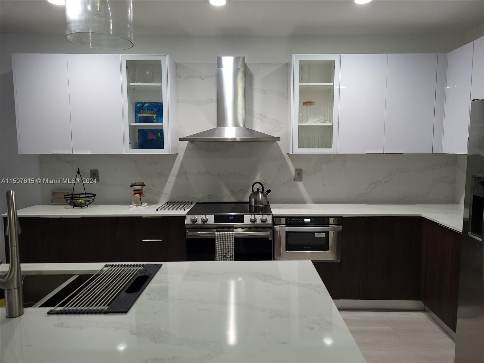 293 Las Brisas Circle Sunrise, FL 33326 - Photo 11 of 69 a kitchen with a stove and a refrigerator