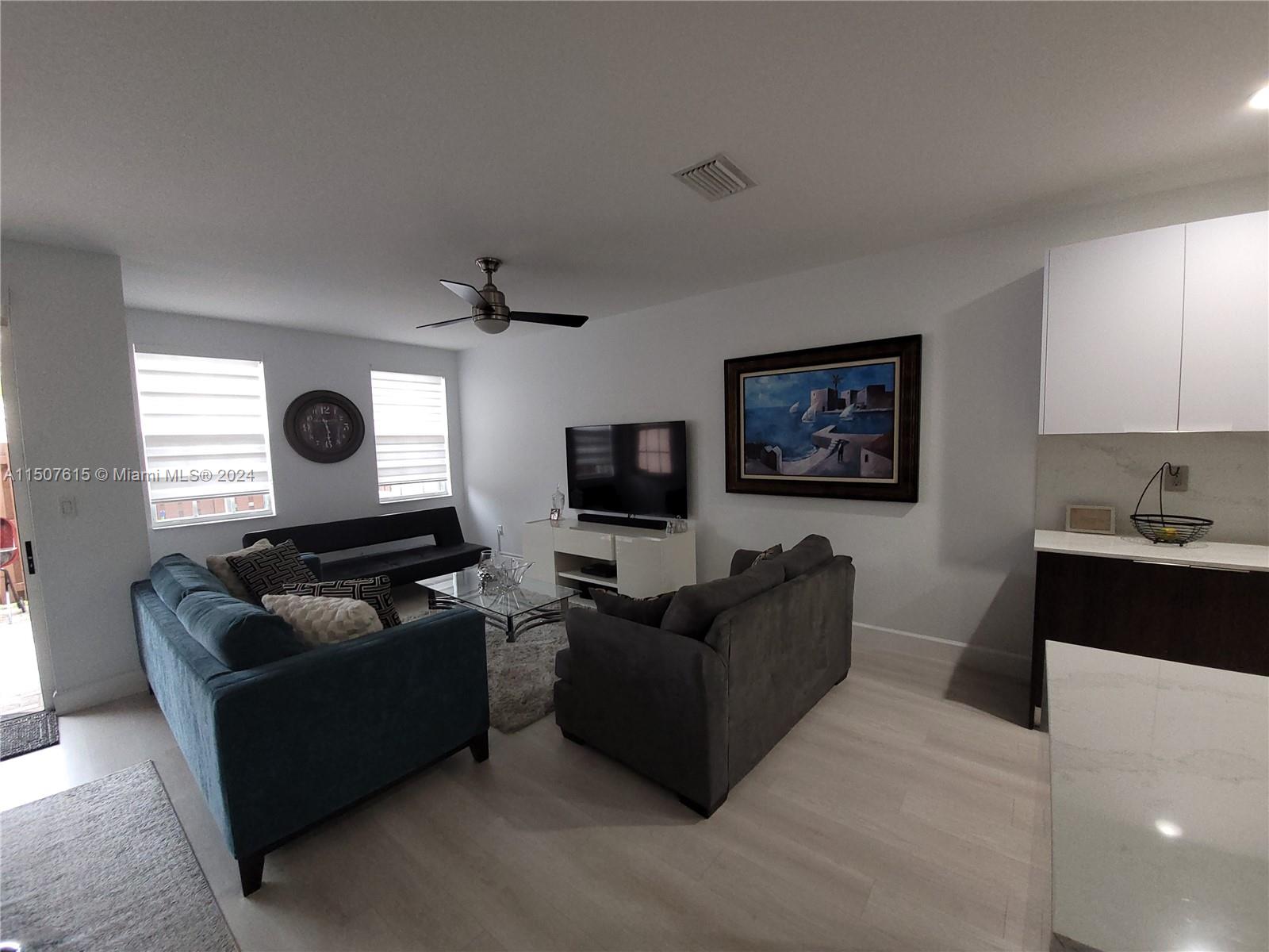 293 Las Brisas Circle Sunrise, FL 33326 - Photo 16 of 69 a living room with furniture and a flat screen tv