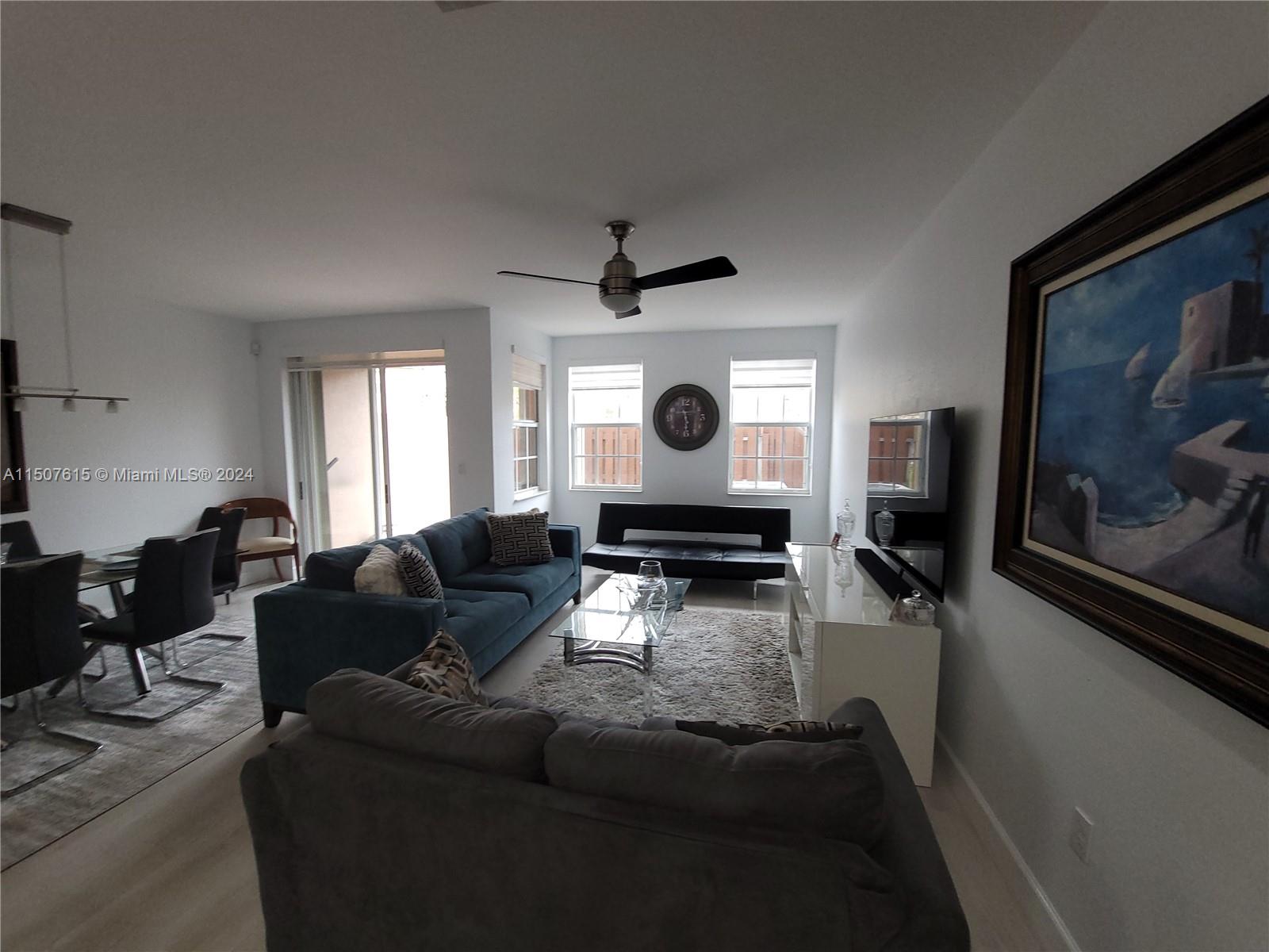 293 Las Brisas Circle Sunrise, FL 33326 - Photo 18 of 69 a living room with furniture and a flat screen tv