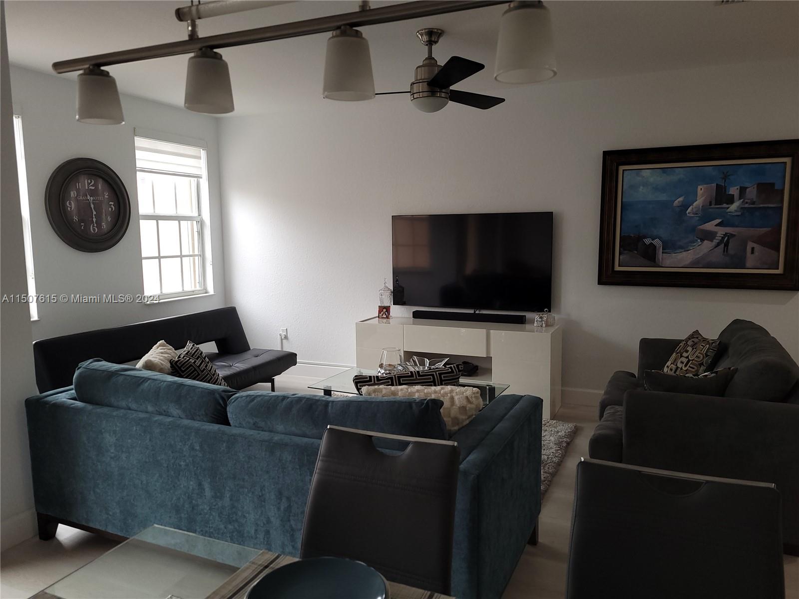 293 Las Brisas Circle Sunrise, FL 33326 - Photo 20 of 69 a living room with furniture and a flat screen tv