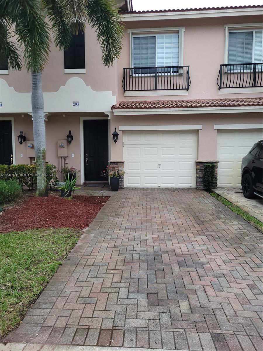 293 Las Brisas Circle Sunrise, FL 33326 - Photo 2 of 69 a front view of a house with a yard and a garage