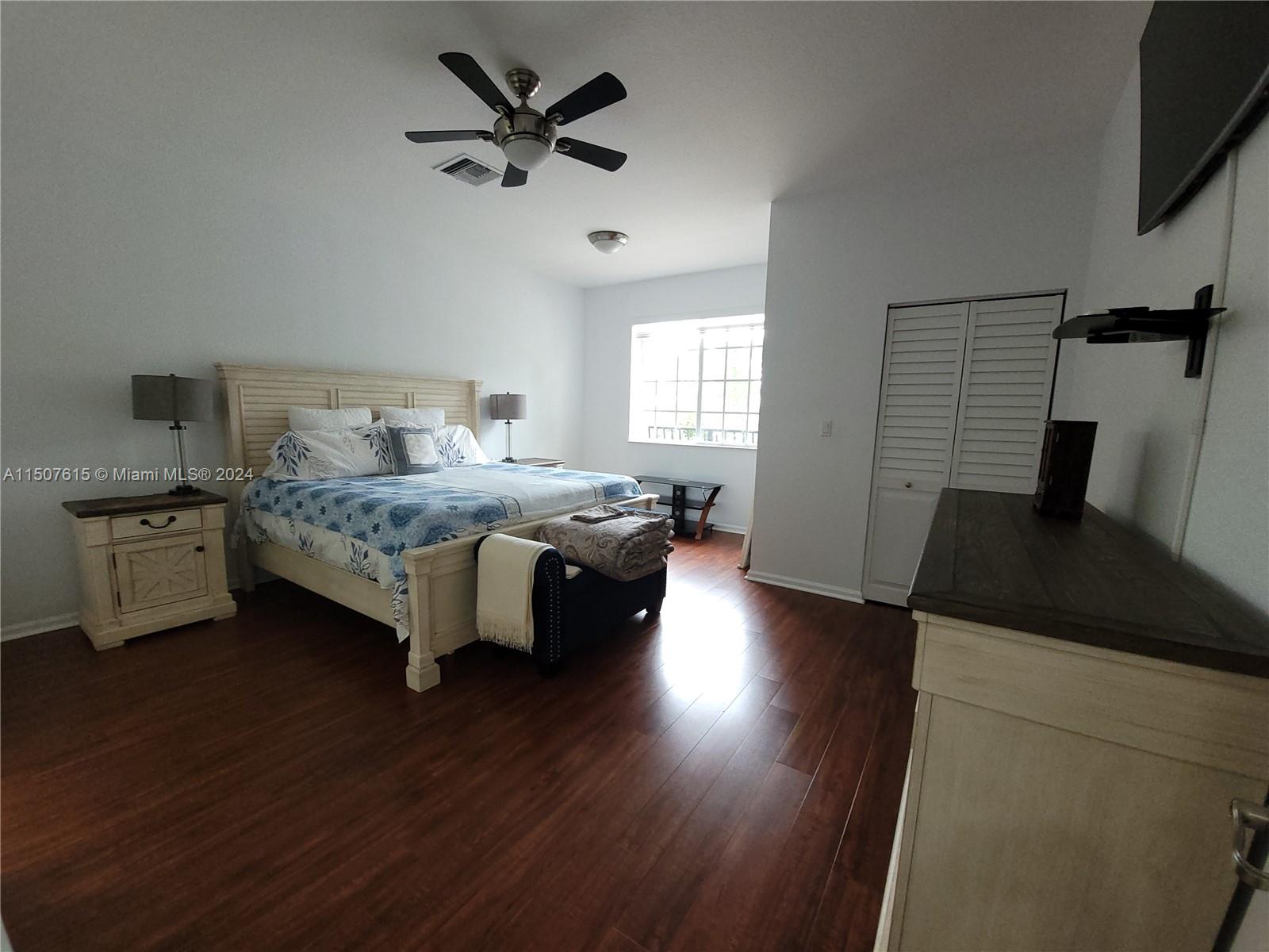 293 Las Brisas Circle Sunrise, FL 33326 - Photo 25 of 69 a bedroom with a bed and a flat tv screen on dresser